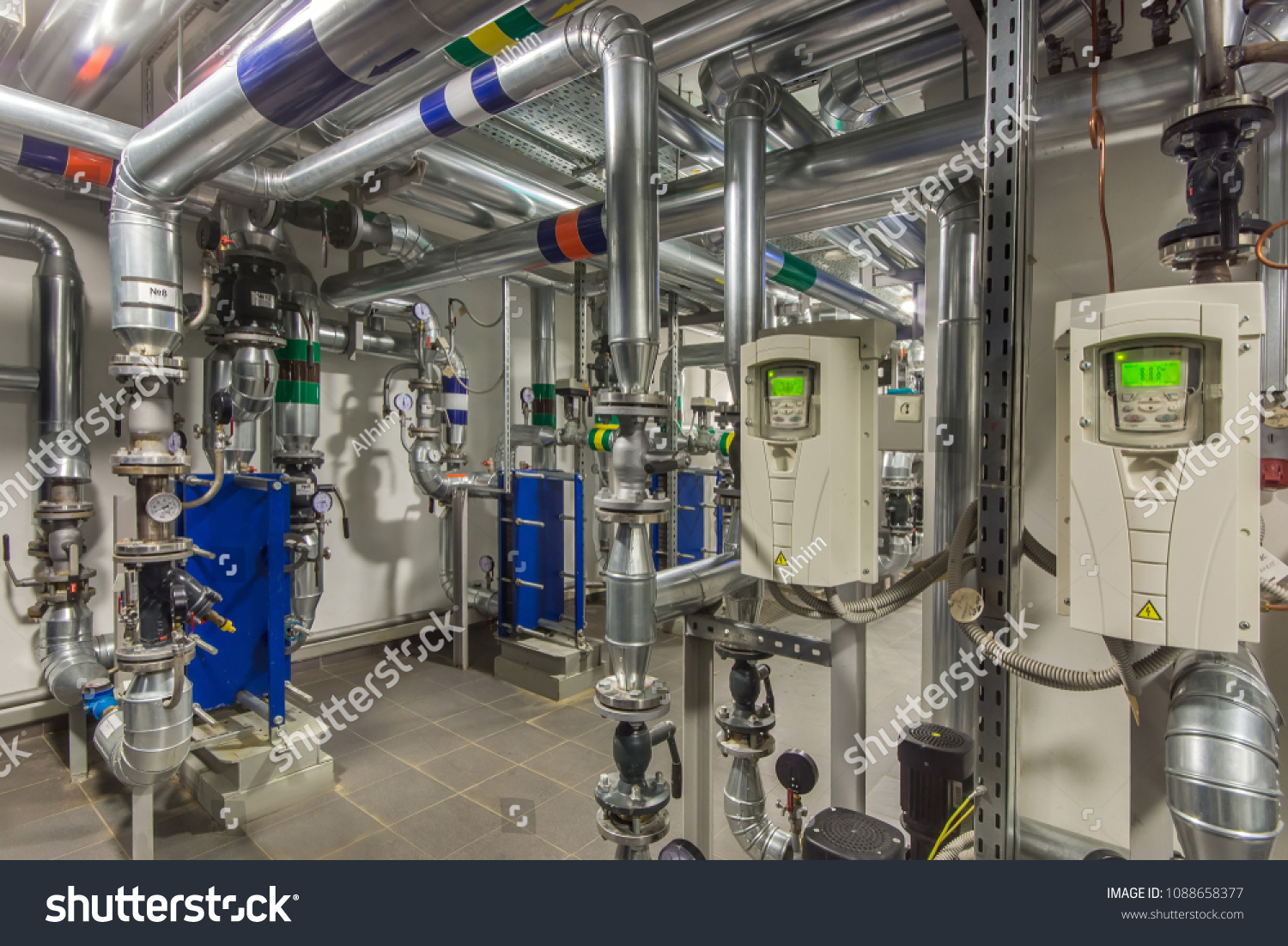 heating-system-in-boiler-room-pipelines-water-pump-valves-manometers-1088658377